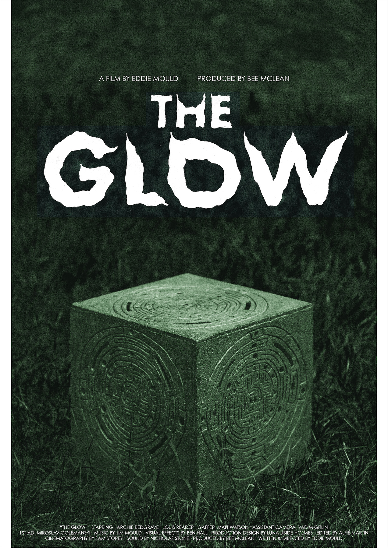 Film poster for 'the glow' featuring a mysterious cube.