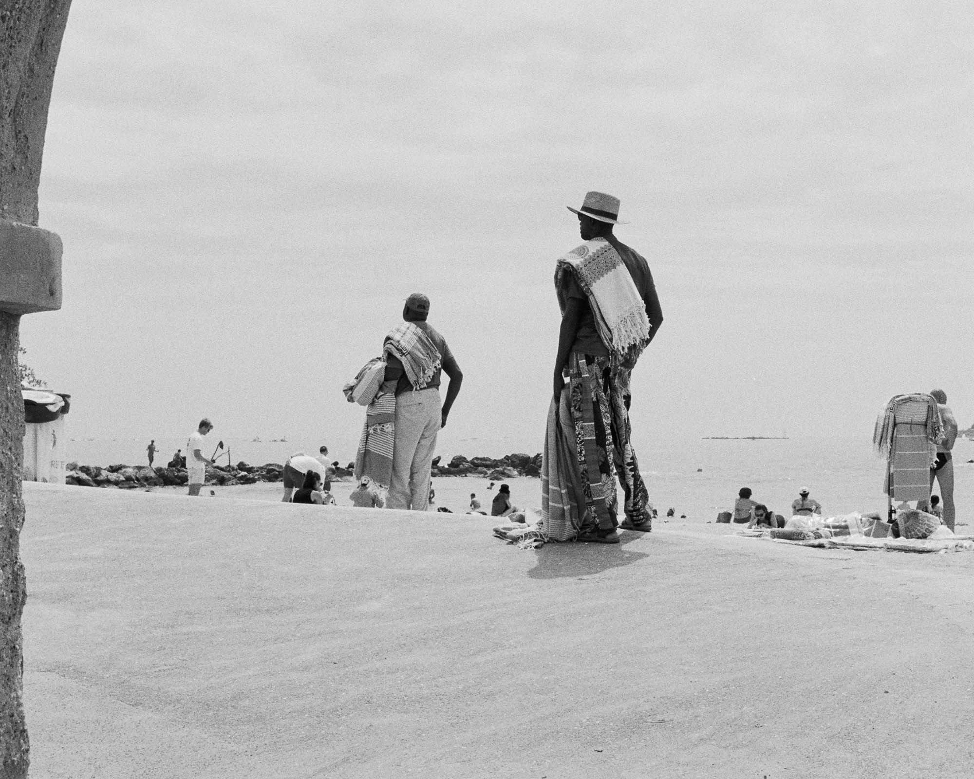 People turned around on a beach in Cannes.