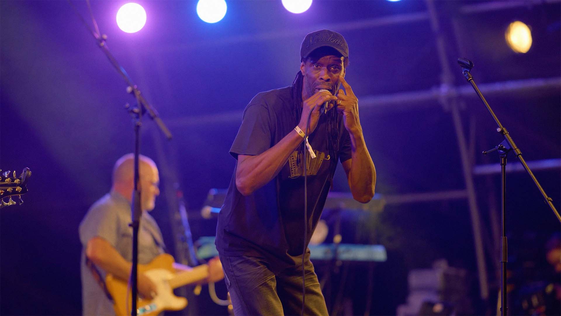 A singer on stage looking at the camera.