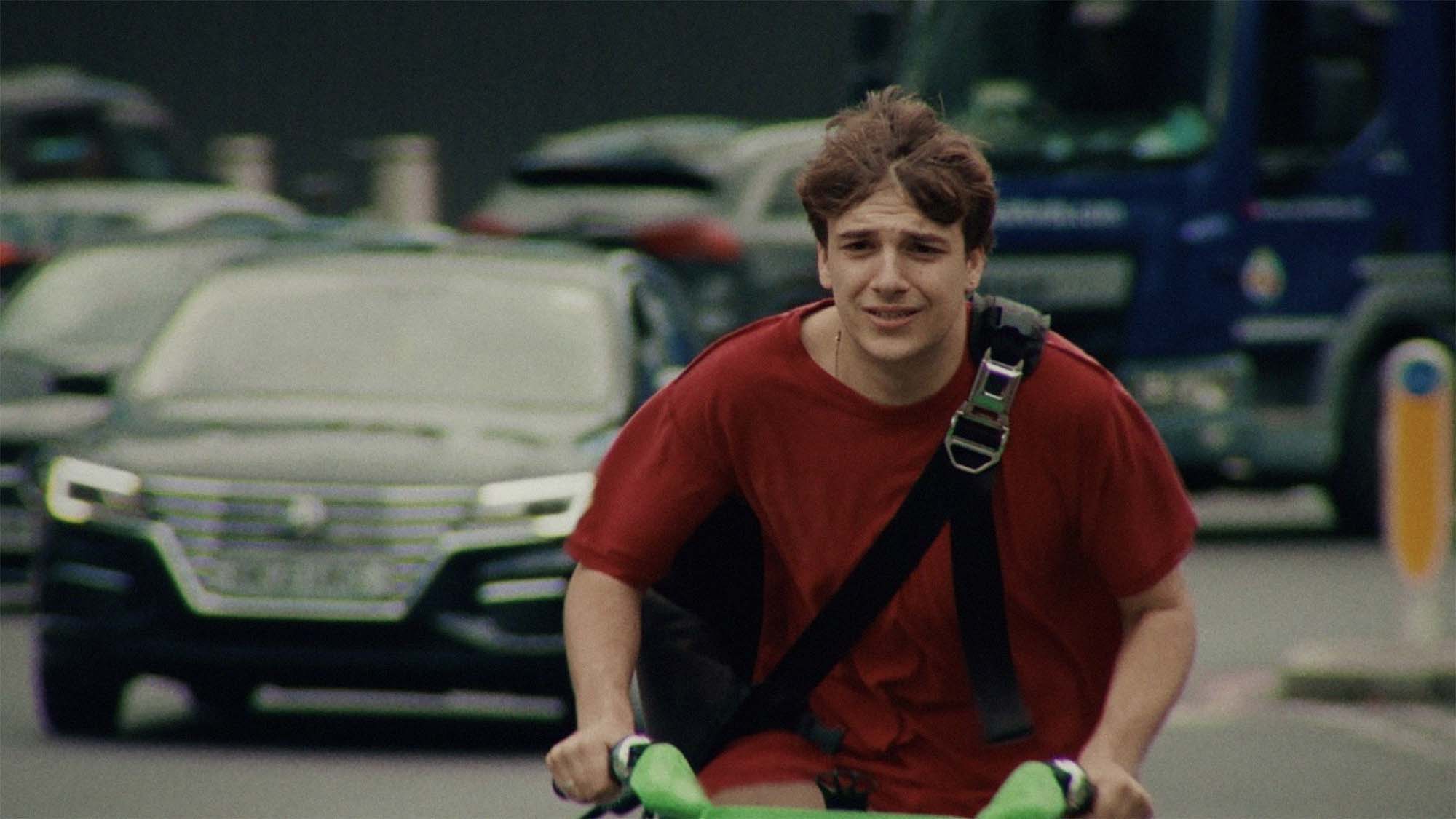 Boy riding a bike looking stressed.